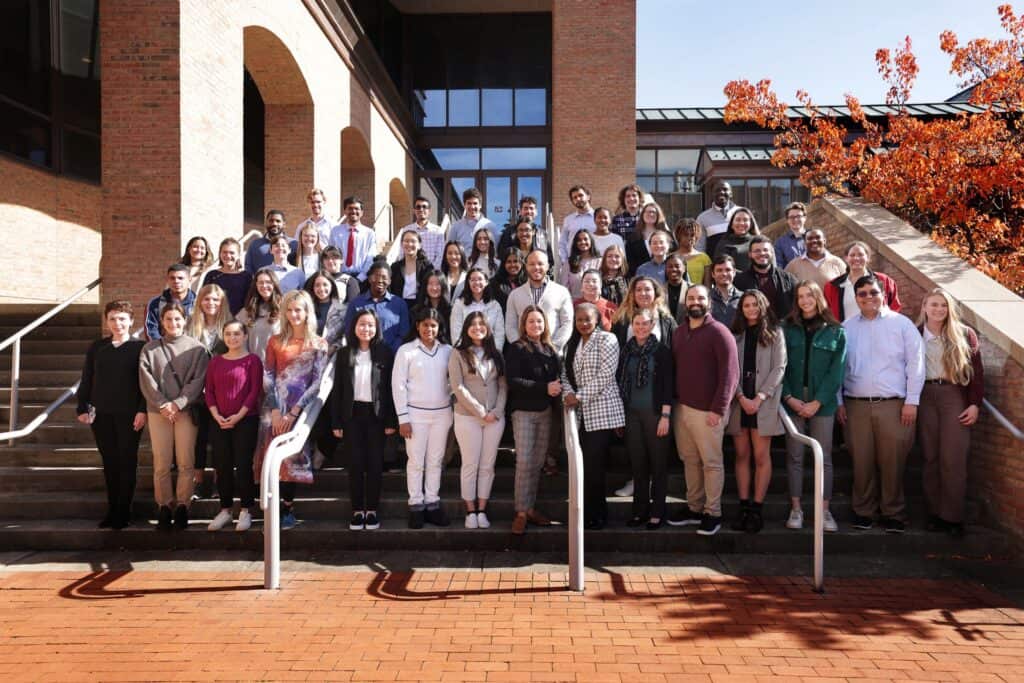 large group of of workshop participants posed in rows on the steps outside Lurie Engineering Center